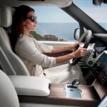 Woman seated upright at the wheel in a spacious car interior
