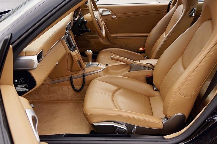 Tan leather car interior with smooth, intact seats and dashboard
