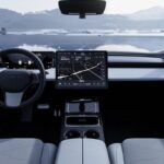 Minimalist car cockpit with a central navigation screen and mountain view